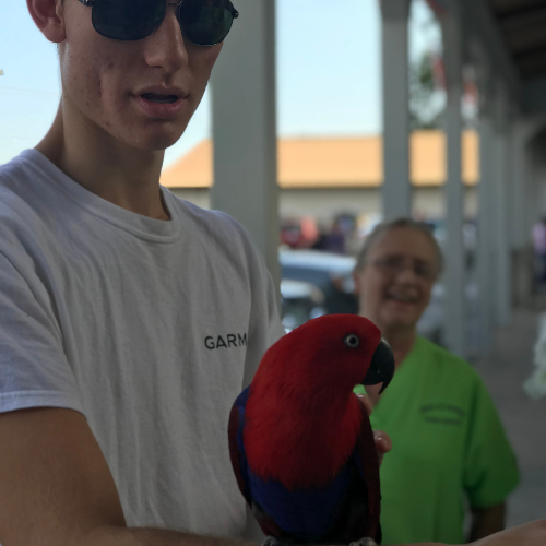 Prairieland Feed staff holding a bird 