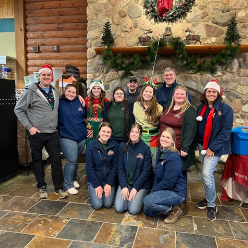 Prairieland Feed staff posing in front of a mantle