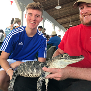 Prairieland staff holding a baby alligator 