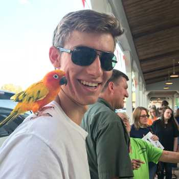 Prairieland staff with a parrot on their shoulder