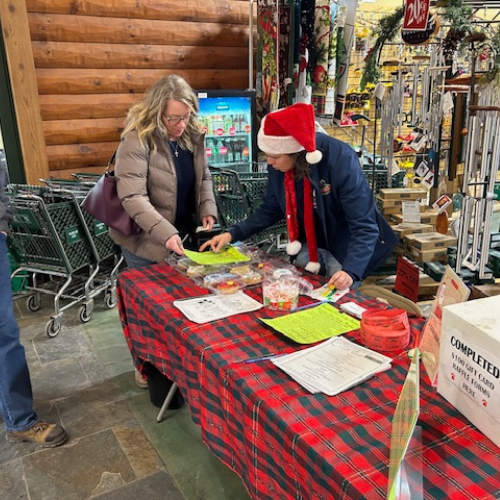 Prairieland Feed staff holding a table event