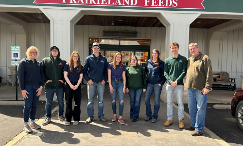 Prairieland Feeds staff in front of the store front